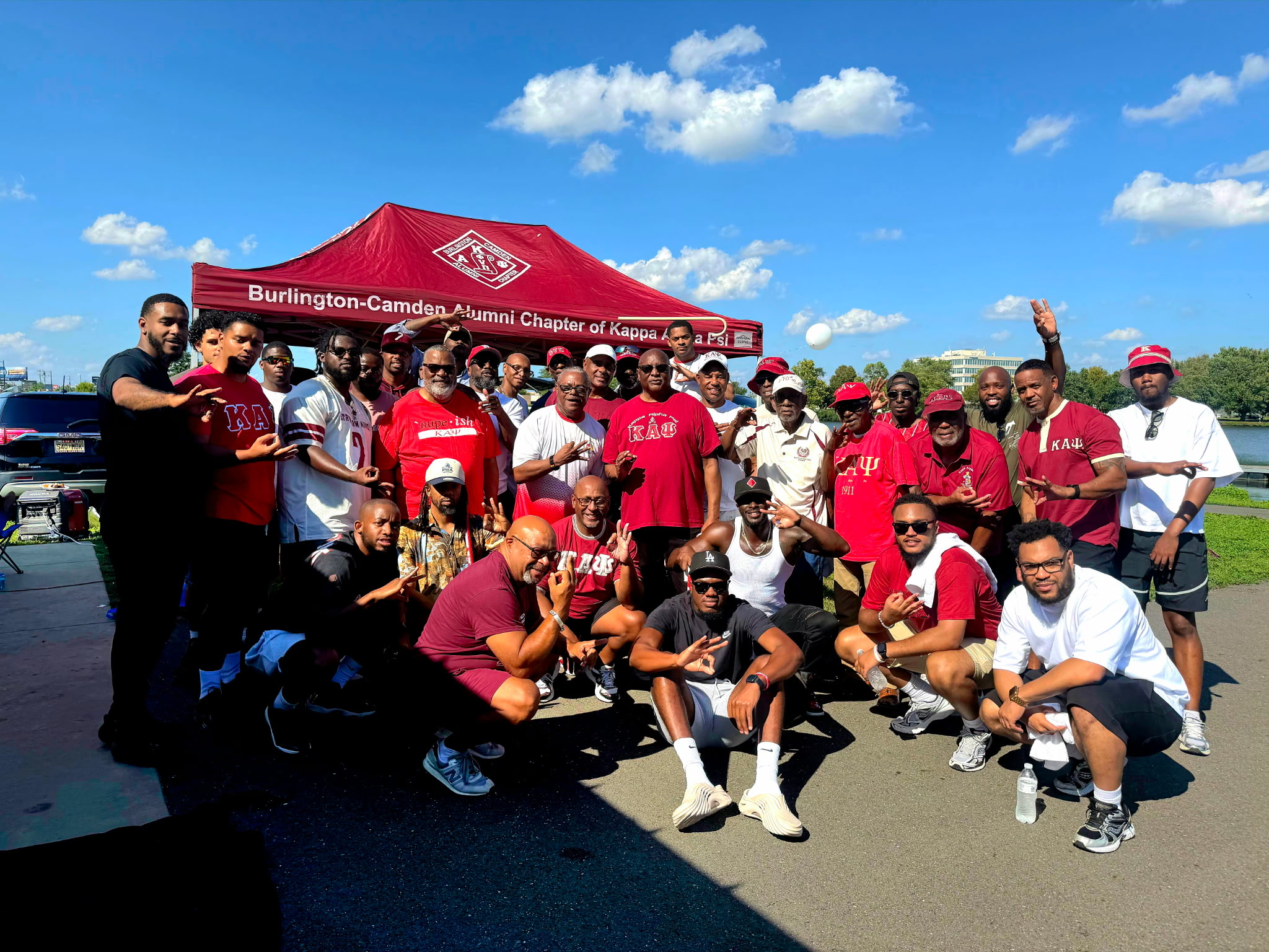 Brothers of the Burlington-Camden Alumni Chapter gathered outdoors at a chapter event
